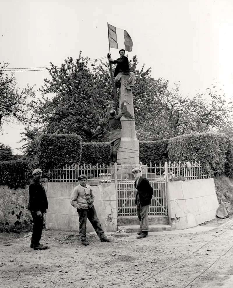 Le drapeau tricolore flotte sur le monument aux morts de Saint-Laurent-sur-mer, 8 juin 1944.